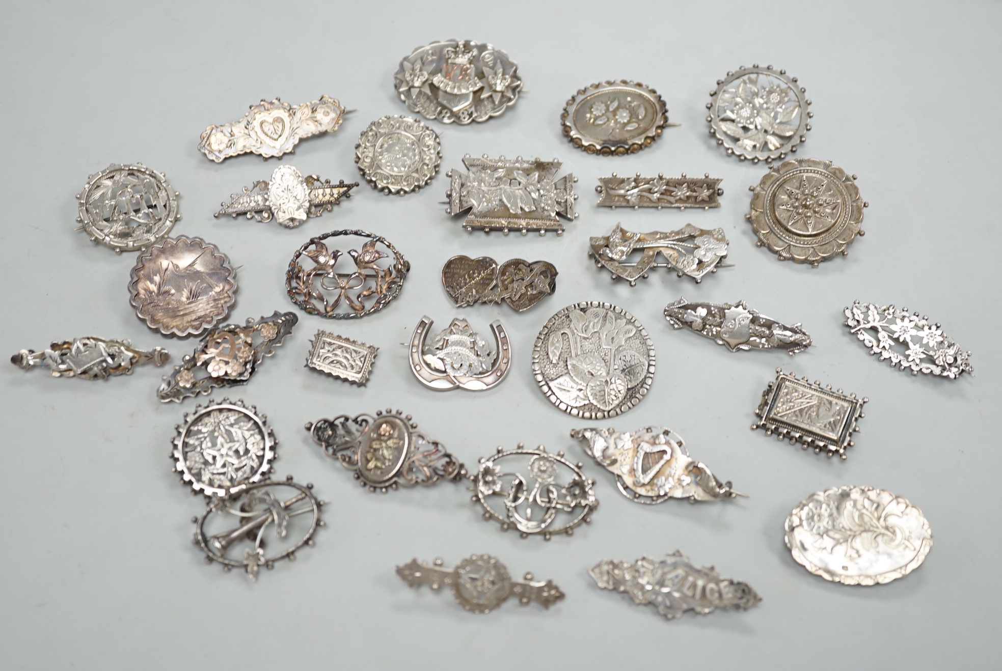 A small collection of twenty nine assorted Victorian and later silver or white metal brooches.